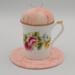 This is the frontal view of the teacup pincushion with the trivet. the flowers are enhanced by the color of the fabric. This is the frontal view of the teacup pincushion with the trivet. the flowers are enhanced by the color of the fabric.
